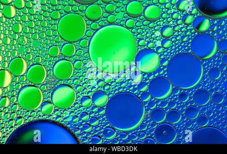 Multi-coloured bubble patterns formed by oil floating on water Stock Photo
