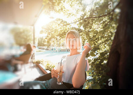 Young woman sitting in cafe Stock Photo