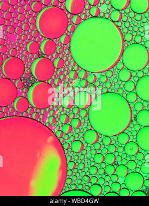 Multi-coloured bubble patterns formed by oil floating on water Stock Photo