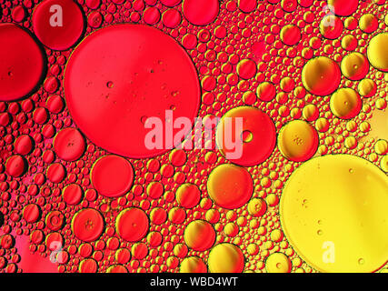 Multi-coloured bubble patterns formed by oil floating on water Stock Photo