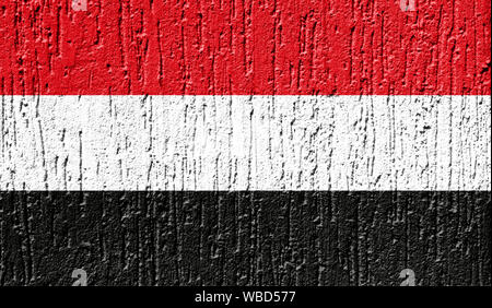 Flag of Yemen close up painted on a cracked wall Stock Photo