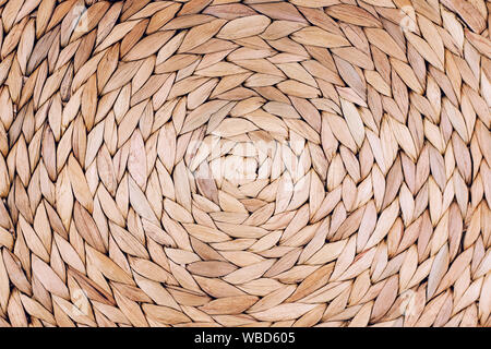 Handmade Wicker placemat made from water hyacinth. Top view, nature background. Stock Photo