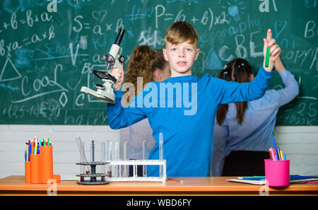 Little children. Science. Little kids scientist earning chemistry in school lab. Lab microscope and testing tubes. Chemistry science. biology experiments with microscope. Biological samples. Stock Photo