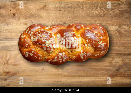 Easter bread, greek tsoureki braid on table, wood background, top view. Stock Photo