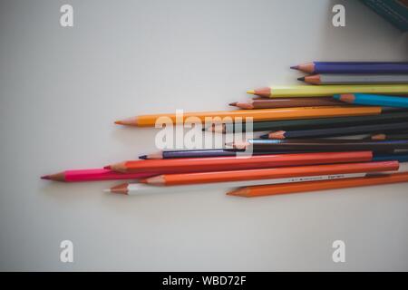Collection of assorted color pencils on a white surface Stock Photo