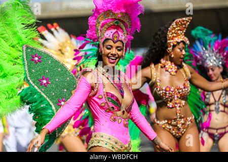 Dancers dressed in colourful costumes during the parade on the second day of the Notting Hill Carnival in west London.Thousands of revellers take part in the Notting Hill Carnival, Europe's largest street party and a celebration of Caribbean traditions and the capital's cultural diversity. Stock Photo