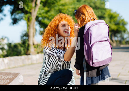 Amazing pupil communicating with her mom before school Stock Photo