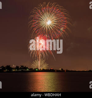 Fireworks Over A Lake - Colorful Fourth of July fireworks light up night sky over Marston Lake, Denver, Colorado, USA. Stock Photo