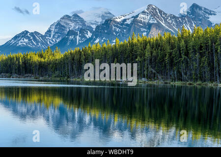 Herbert Lake - A Spring sunset view of Herbert Lake and its surrounding high mountain peaks, Banff National Park, AB, Canada. Stock Photo