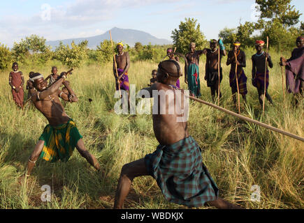 Mursi warriors during a stick fight in Mago National Park, Lower Omo Valley, Ethiopia Stock Photo