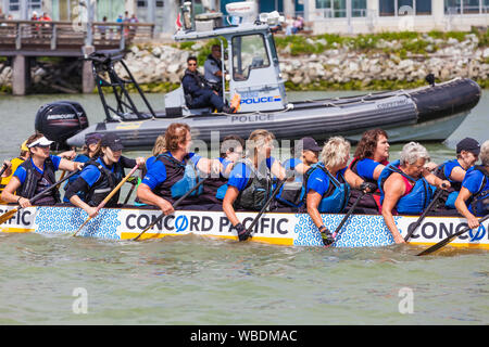 Female team returning to the dock after their race at the 2019 Steveston Dragon Boat Festival in British Columbia Canada Stock Photo