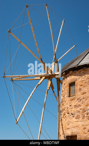 Old Greek windmill against blue sky. Patmos Island, Greece.