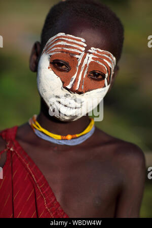 Beautiful tribal Suri girl at a ceremony in Lower Omo Valley near Kibish, Ethiopia Stock Photo