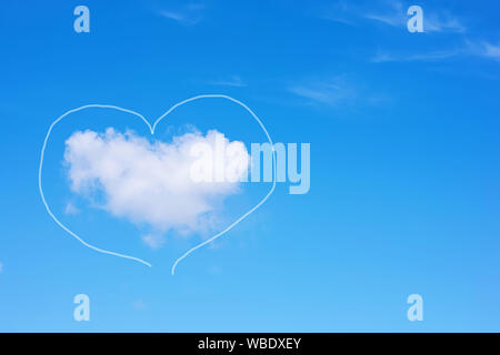 Heart-shaped cloud on a blue sky. Copy space. Concept of love, romance and valentines day. Stock Photo