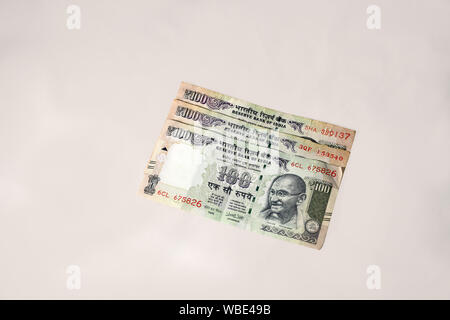 Old Indian One Hundred Rupees Currency Notes on a minimal grey background Stock Photo