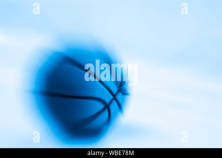 Blurred zoom of Basketball ball on blue background Stock Photo