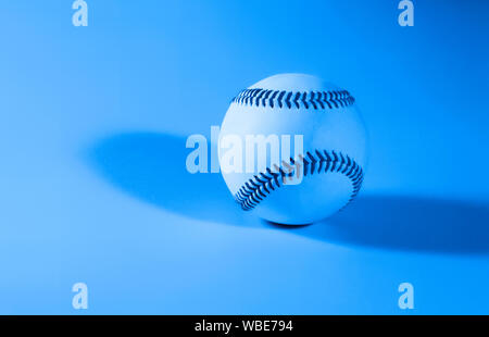 baseball on a blue color background and red stitching baseball. copy space Stock Photo