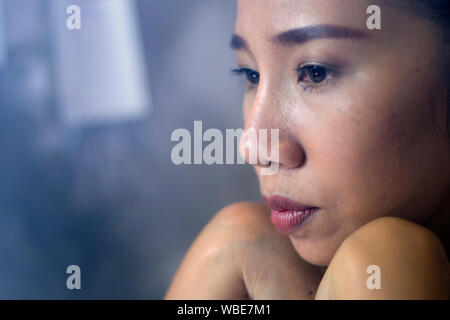 Asian woman worker suffering from hurt,fatigue, pain at neck, muscle, stressed during working with laptop for a long time, Stock Photo