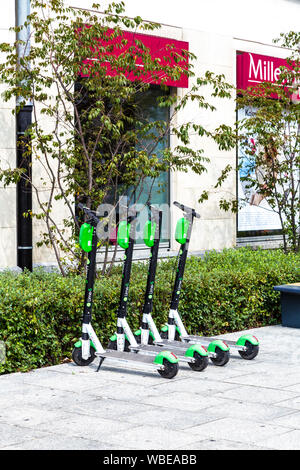Rental Lime-S electric scooters parked on the street in Warsaw, Poland Stock Photo