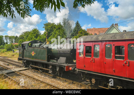 CRANMORE, ENGLAND - JULY 2019: Steam engine pulling a train departing from Cranmore Station on the East Somerset Railway. Stock Photo