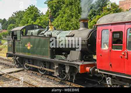 CRANMORE, ENGLAND - JULY 2019: Steam engine pulling a train departing from Cranmore Station on the East Somerset Railway. Stock Photo