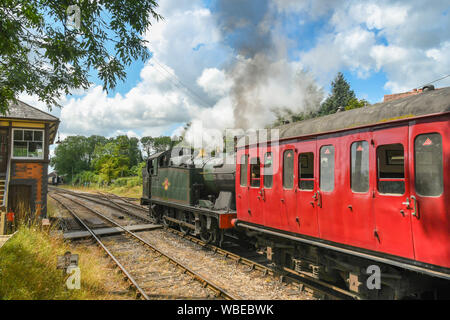 CRANMORE, ENGLAND - JULY 2019: Steam engine pulling a train departing from Cranmore Station on the East Somerset Railway. Stock Photo