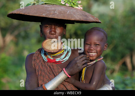 Suri woman with lipplate in South Omo, Ethiopia. A resettlement program threatens the tribes in Ethiopia. Stock Photo