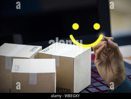 Conceptual the customer responded to the survey. The client writing a smile face icon after shopping online. Depicts that customer is very satisfied. Stock Photo