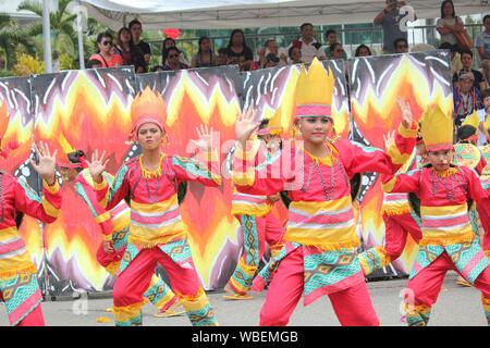 Davao City, Philippines-August 2014: Lively performance of street dancers at the Kadayawan festival with crowds watching from the sidelines. Kadayawan Stock Photo