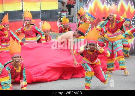 Davao City, Philippines-August 2014: Lively performance of street dancers in colorful props and costumes at the Kadayawan festival.  Kadayawan is cele Stock Photo