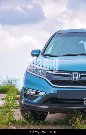 mnt. runa, ukraine - jun 22, 2019: honda cr-v suv on a paved platform in mountains. popular family vehicle, in cyan blue color. cloudy day and even li Stock Photo