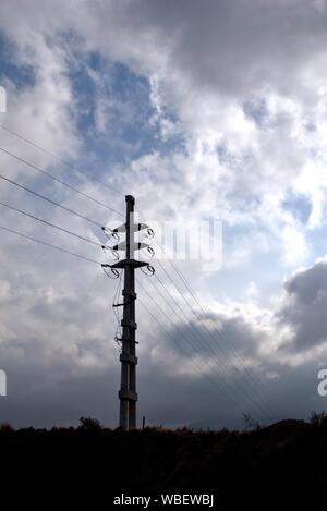 Electrical power pylon and cloudy blue sky Stock Photo - Alamy