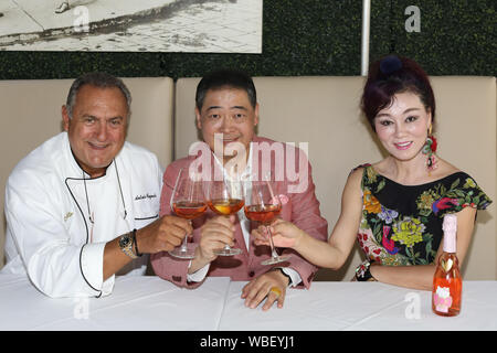 Santa Ana, California, USA. 23rd August, 2019. TV host Joey Zhou and  Celebrity Chef Antonio Cagnolo celebrate the introduction of a Chinese  language menu and Chinese-Italian cuisine at Quattro Caffe located at