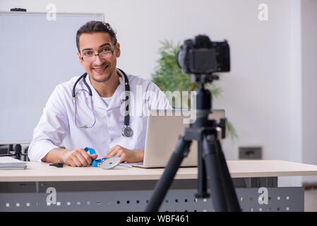 The young male doctor recording video for his blog Stock Photo