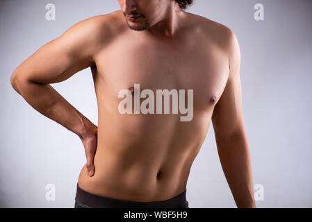 The man suffering from backbain on gray Stock Photo