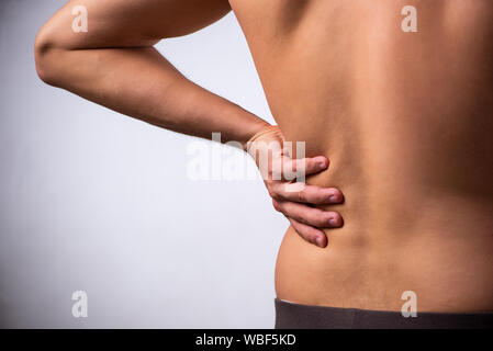 The man suffering from backbain on gray Stock Photo