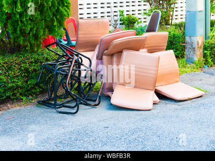 office chair leather brown old damage dirty heap on the floor road Stock Photo