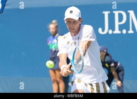 Tomas Berdych of the Czech Republic returns the ball to Uzbekistan's ...