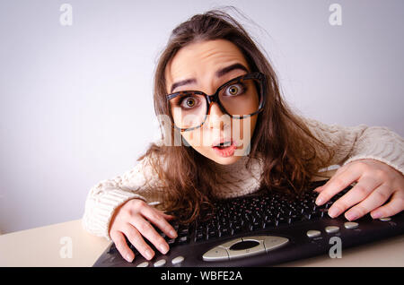 The funny nerd girl working on computer Stock Photo