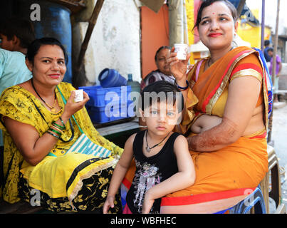 Indian women from Madhya Pradesh drinking tea in a small tea-shop in Varanasi, India. Stock Photo