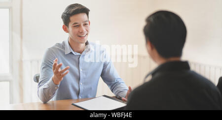 Attractive young professional businessman explaining his idea concepts to his team member Stock Photo