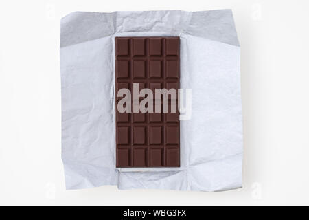 Chocolate bar organic in foil isolated on white background. Stock Photo