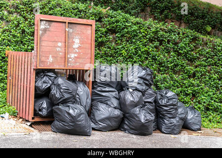 Big pile of black plastic garbage bags with trash stacked on the street trash  bags. on the street at utility workers strike day Stock Photo - Alamy