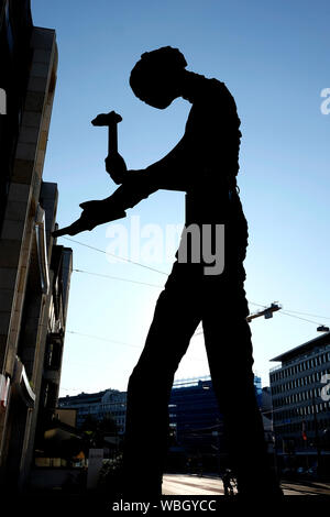 Hammering man in silhouette, a giant sculpture by the American artist Jonathan Borofsky. Bael, Switzerland Stock Photo