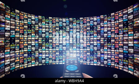 Image of big screen with many multi-colored channels, hands of man with remote control on blank black background Stock Photo