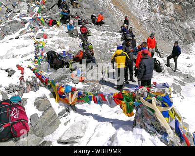 NEPAL, CHO LA - APRIL 02, 2018: tourists have a rest on Cho La pass (5420 m), Nepal on April 02, 2018. Pass connects the Gokyo valley with the Everest Stock Photo