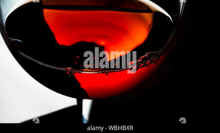 black reflective, pouring wine, shot black, wallpaper, black background, stock photo, macro shot, wine glass, slow motion Stock Photo