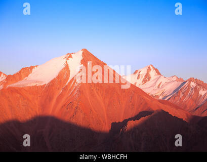 Majestic mountain peaks at sunset; boundless cloudless blue sky especially for your text Stock Photo