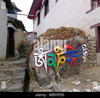 Ancient Buddhist Mani stone with engraved sacred mantra 'Om Mani Padme Hum' in Tengboche monastery; trek to Everest base camp, Sagarmatha national par Stock Photo