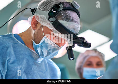 surgeons in the operating room during surgery Stock Photo